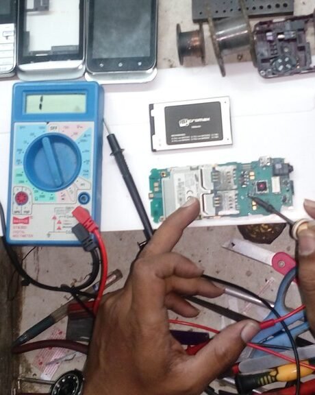 A repair bench with an opened smartphone and tools